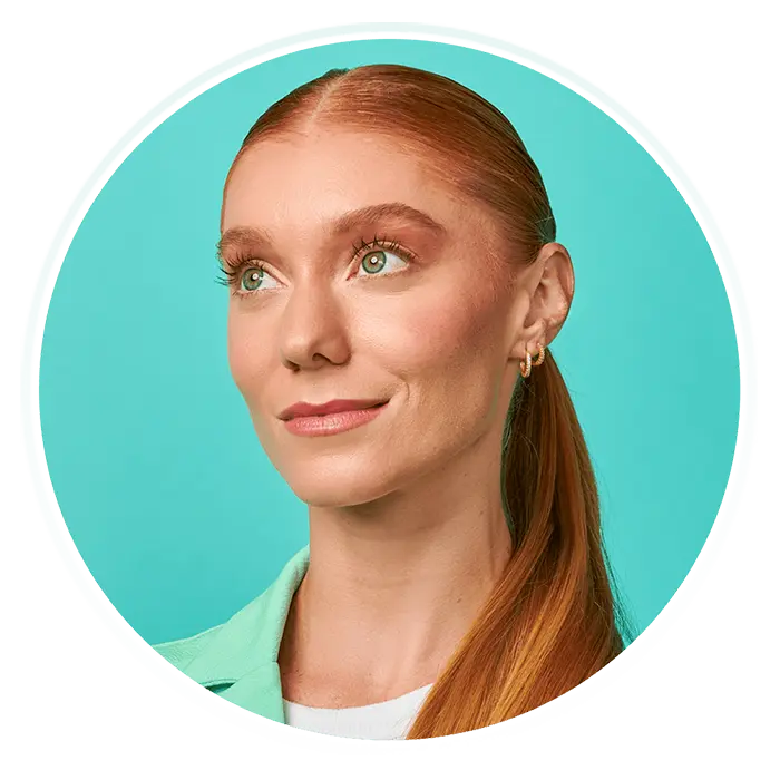 A woman with red hair and a green shirt.